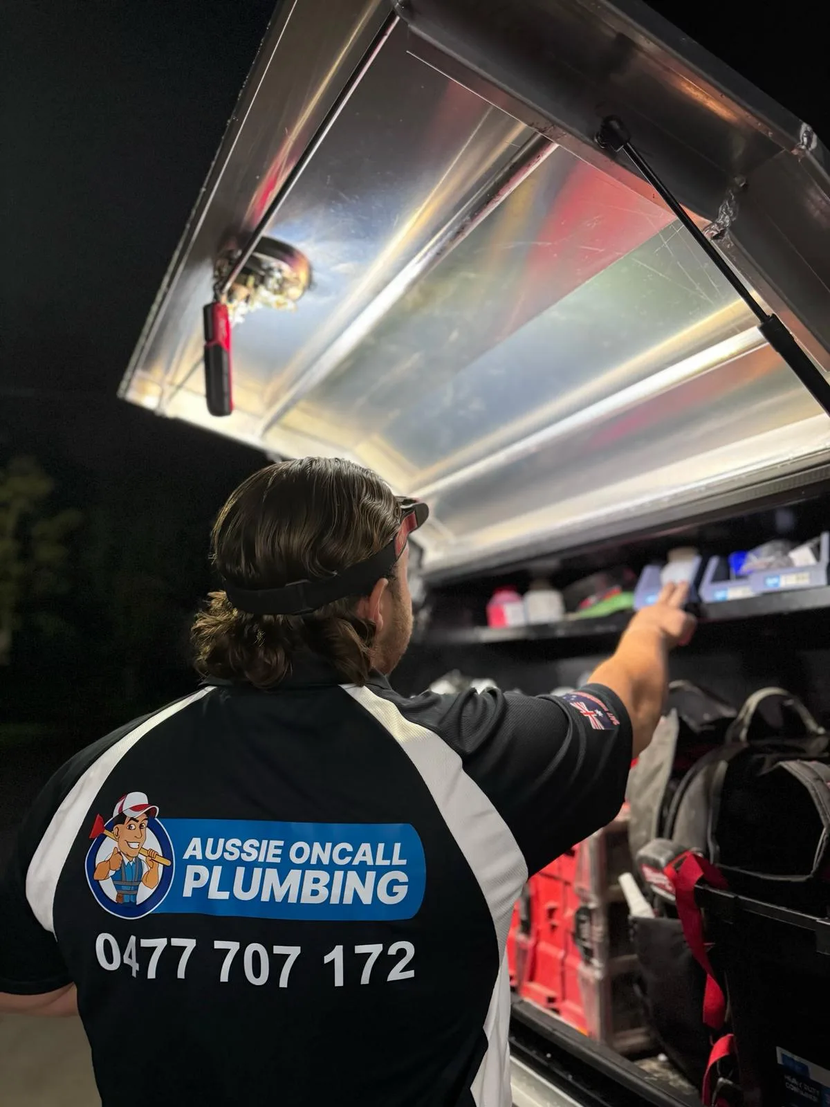 Grabbing gear from the service van on a night emergency call-out